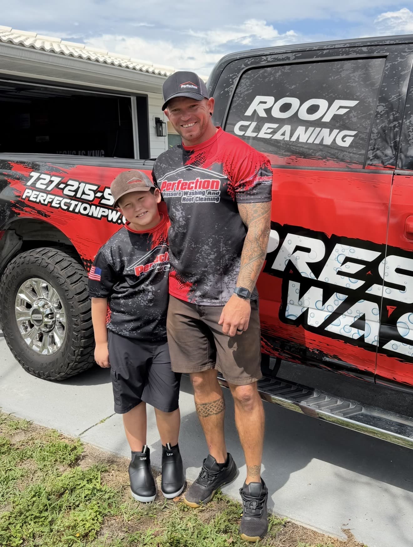 Ryan Murphy and his son beside the wrapped Perfection Pressure Washing truck