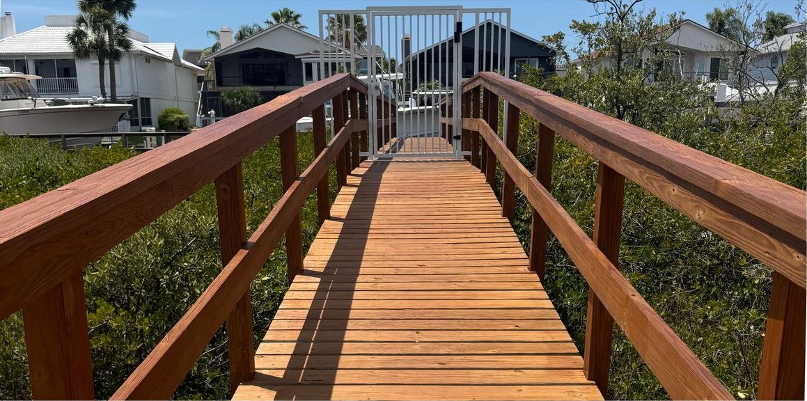 Wooden walkway and railings after staining and sealing at Sea View Place, a condo community in Tarpon Springs.