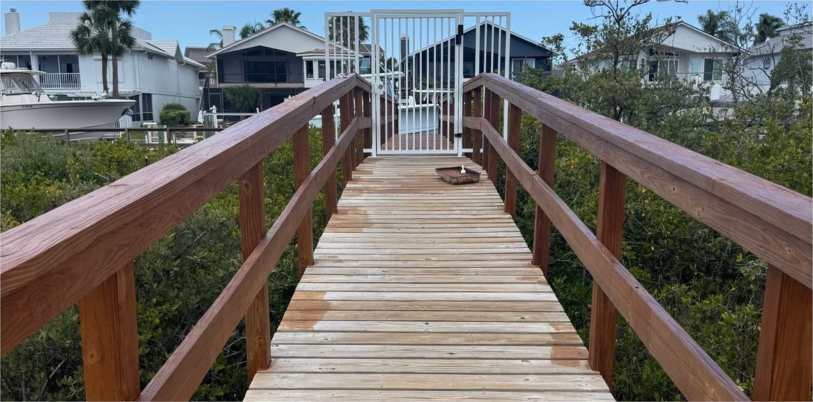 Wooden walkway and railings before staining and sealing at Sea View Place, a condo community in Tarpon Springs.