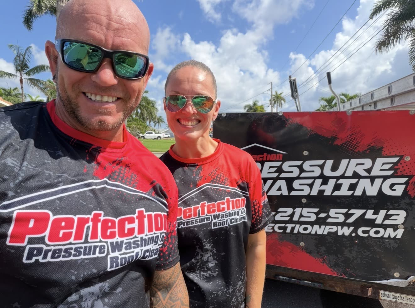 Ryan and Jenn Murphy beside the Perfection Pressure Washing trailer